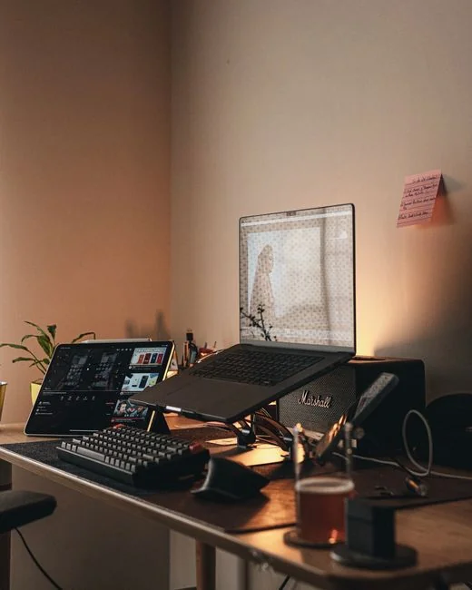 High-angle view of a stylish work desk featuring dual monitors, keyboard, mouse, and modern accessories.